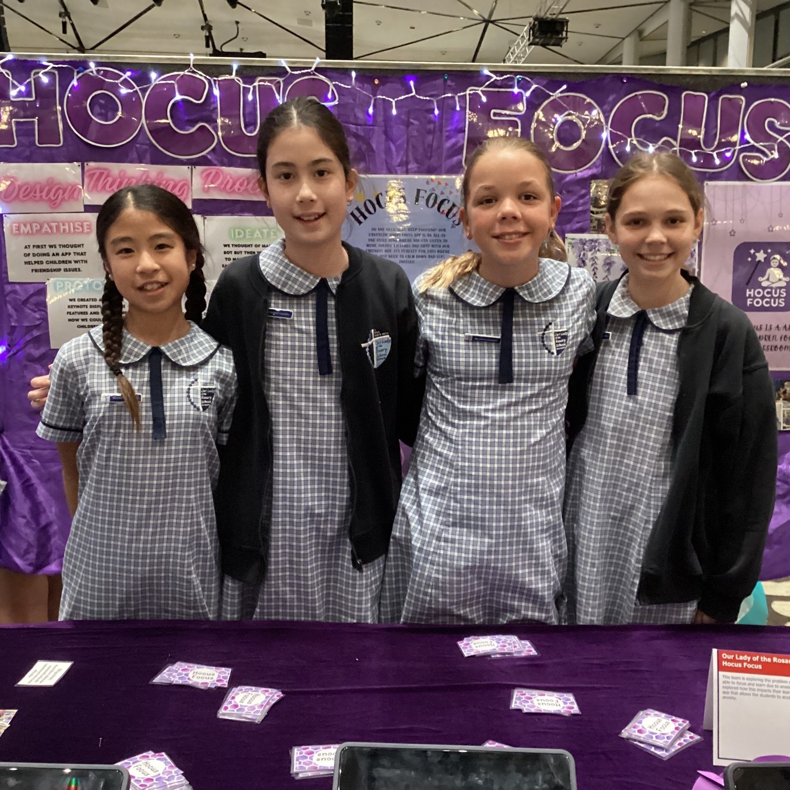 Students presenting a project at a school exhibition display.
